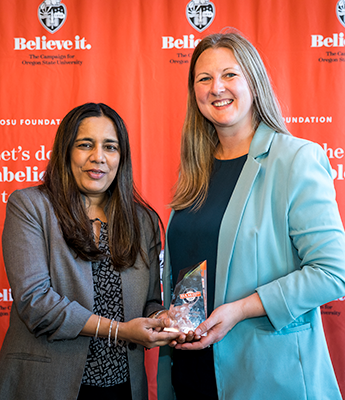 A person from College of Forestry receiving the Dean's Cup award.