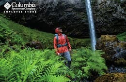 Man wearing Columbia Sportswear clothing while on a hike in a green forest