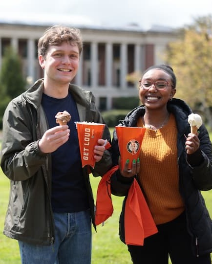 two students at Dam Proud Day 2022 holding icecream cones on a sunny day