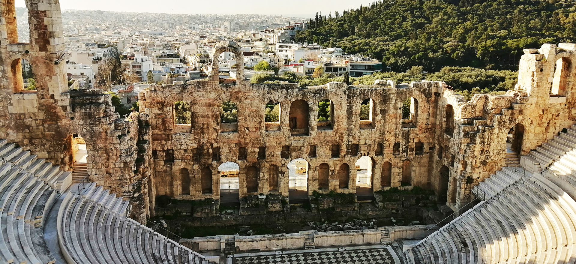 View of ancient Roman Theatre in Athens. City is in the background.