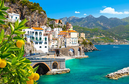 Coastal Mediterranean town with green brush and clear water