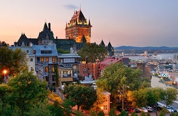 Buildings and trees on a hill overlook city