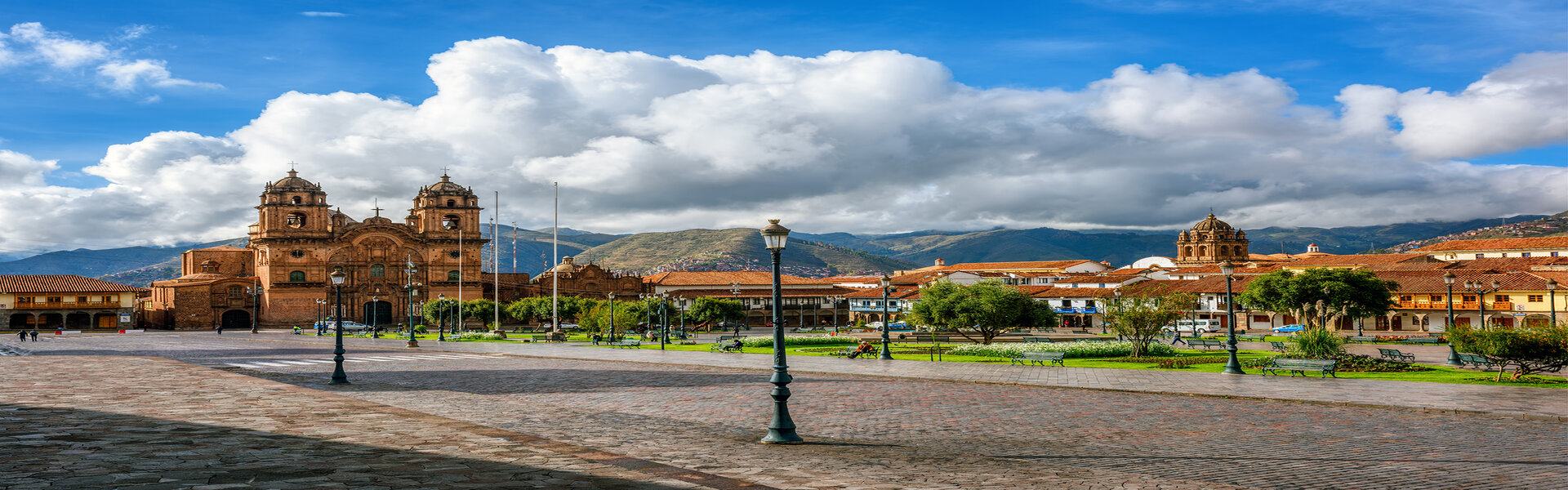 Cathedral overlooks town with greenery and cobble streets