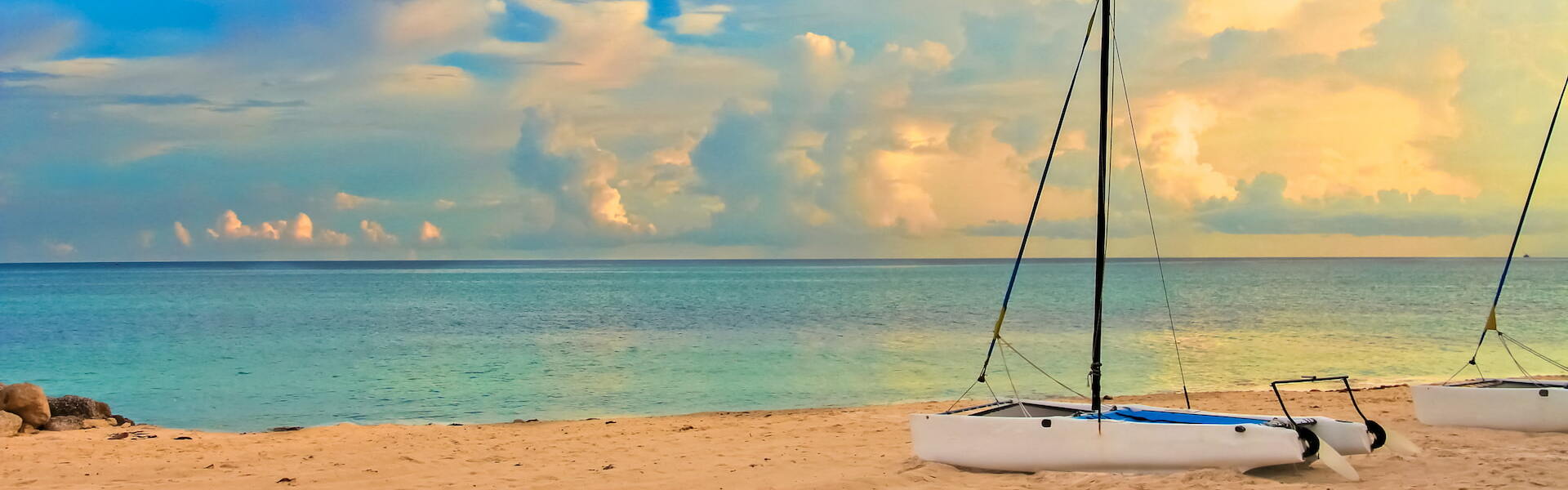 Beach view with sand and a boat on the shore of Freeport, Bahamas