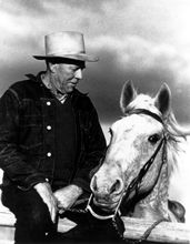 Reuben A Long with his white horse, in black and white