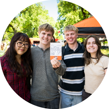 Students holding a SketchBot illustration.