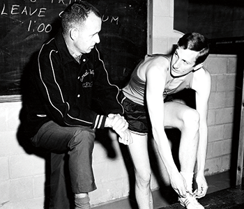 Photo of longtime OSU men’s track coach Bernie Wagner checking in with his star jumper, Dick Fosbury.