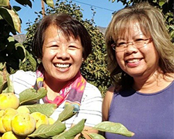 Maria Ester Aguila '80 and Veronica Aguila Allen '89 outdoors portrait