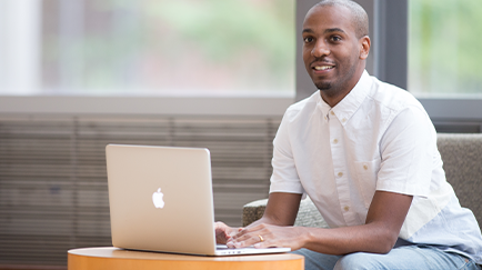 An Ecampus student using a laptop.
